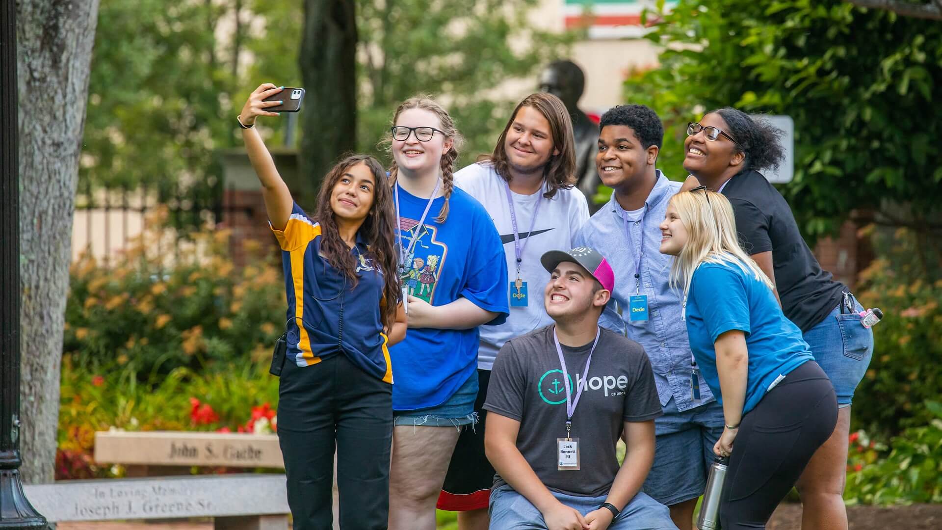 group of high school students taking photo with JWU student