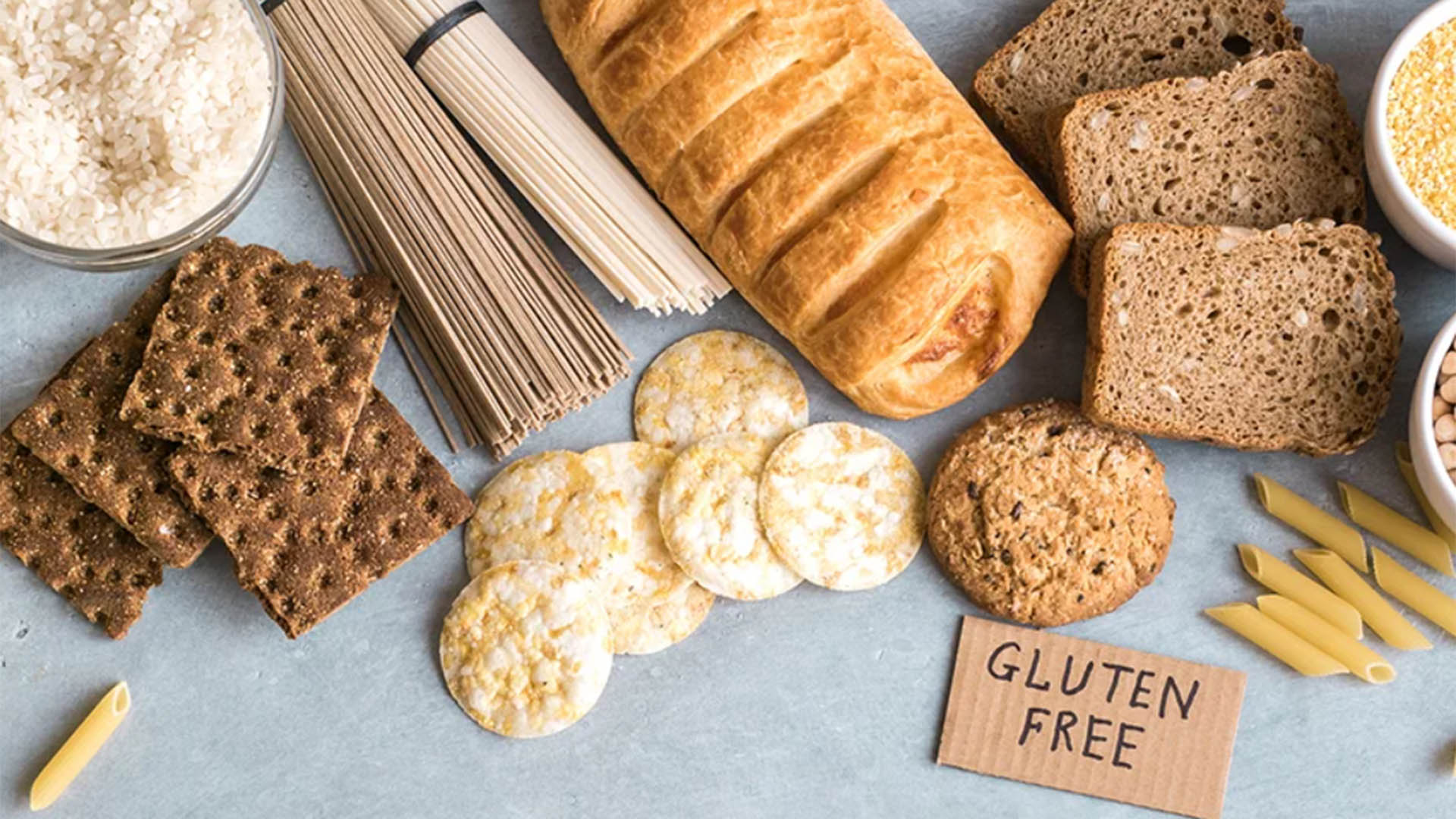 a photo showing a range of carbohydrates such as bread, crackers and pasta with a small sign reading "gluten free"