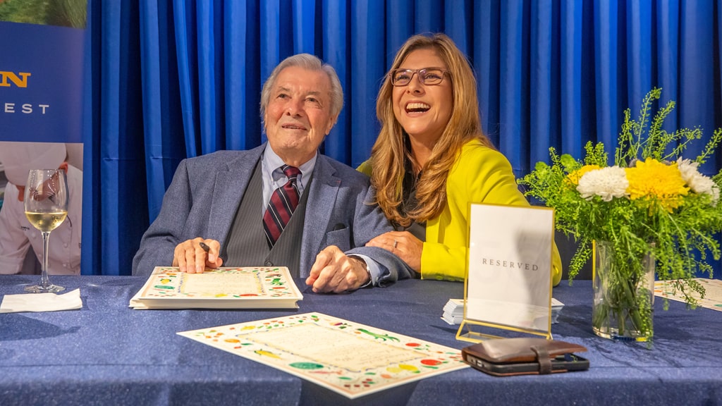 Jacques Pepin '10 Hon. signing artwork at the CFIT Gala, with Lorena Garcia '00, '14 Hon.