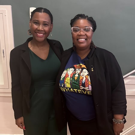 Kaitlyn Rabb of Rhode Island KIDS Count (left) and Quatia “Q” Osorio, the executive director of the Urban Perinatal Education Center, at JWU Providence.