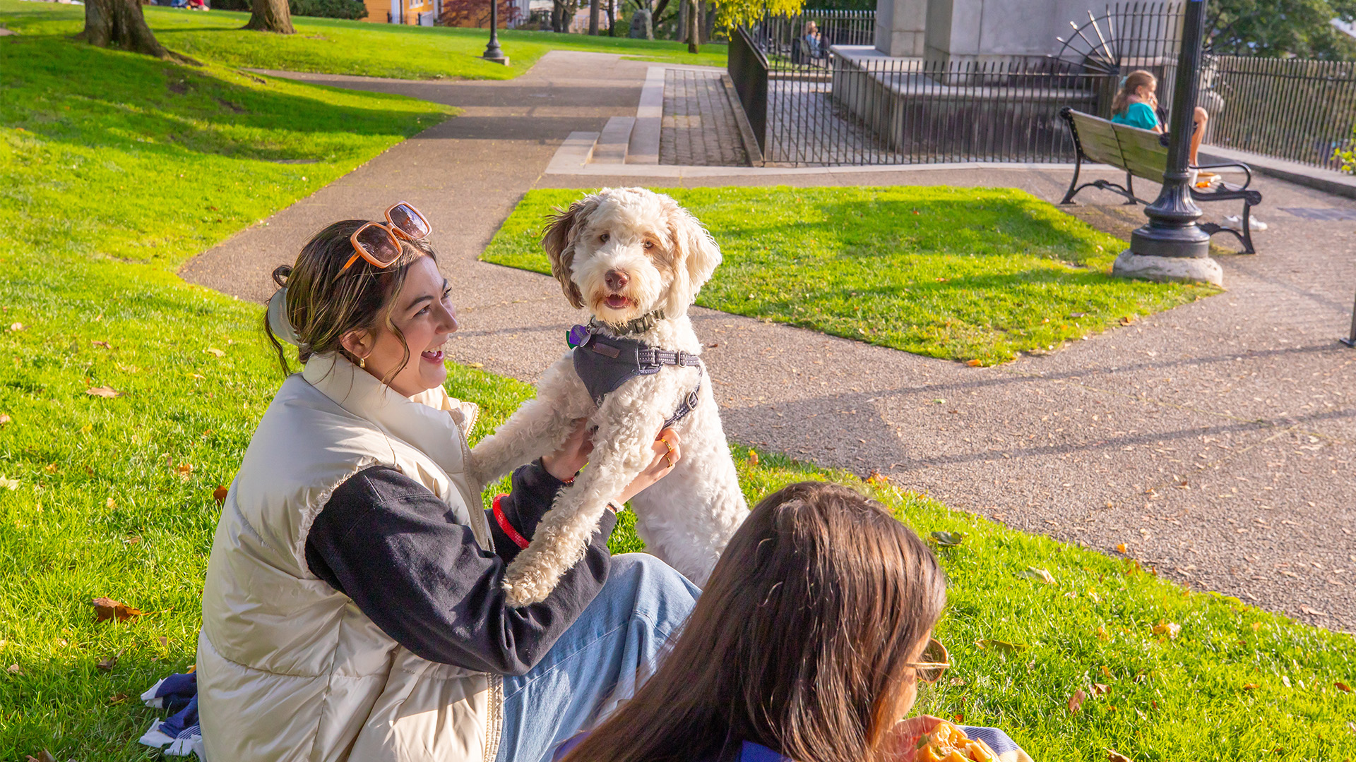 Students sitting with dog outside