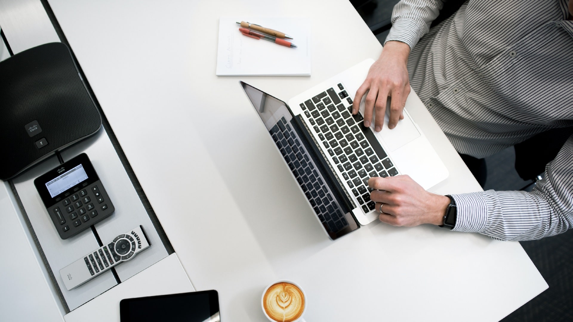 a man typing on his computer 