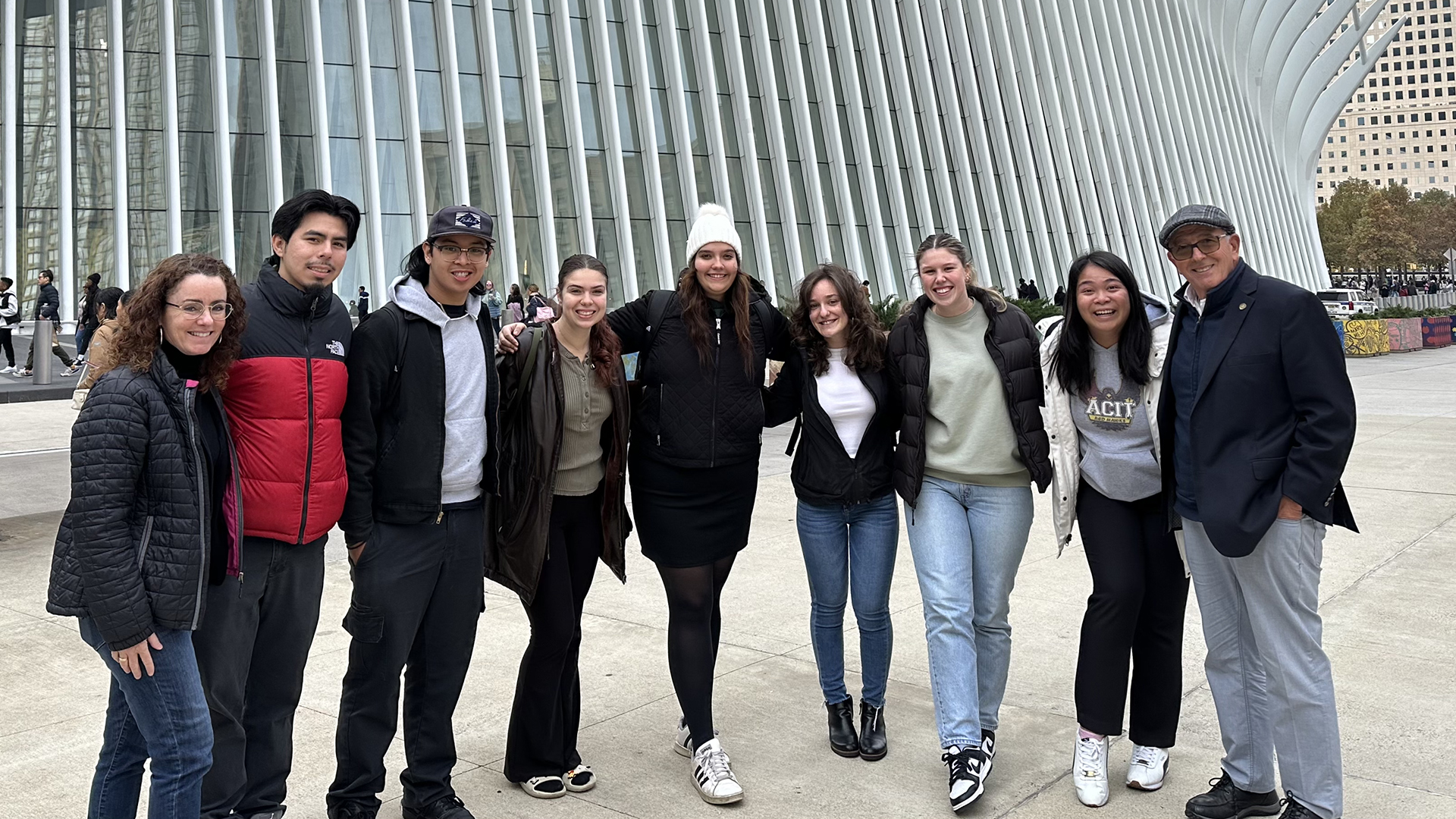 Professor Gail McCarthy, Edison Calle, Cyrell Faraon, Emme Romanelli, Shannon Tapley, Caroline Kornberg, Kyra Northup, Hillary Thilavong and Professor Oscar Chilabato at the World Trade Center.