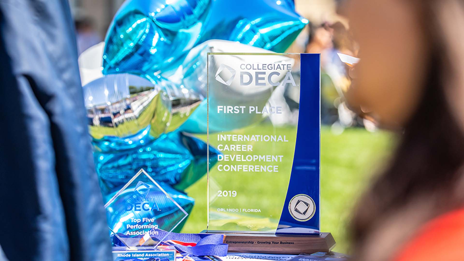 The Collegiate DECA trophy on a table