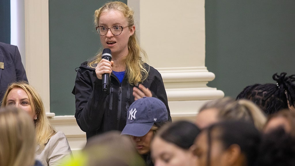 JWU senior Emma Smith '24 asks a question from the audience at JWU's 2023 VIP lecture