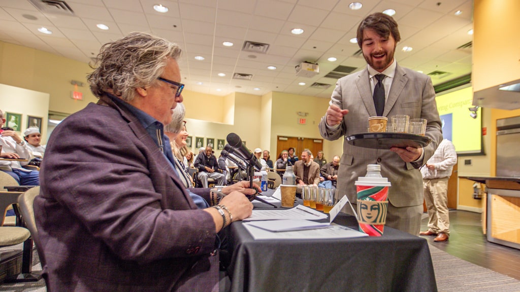 Max Stanger offers a taste of mead to judge David Burke '23 Hon.