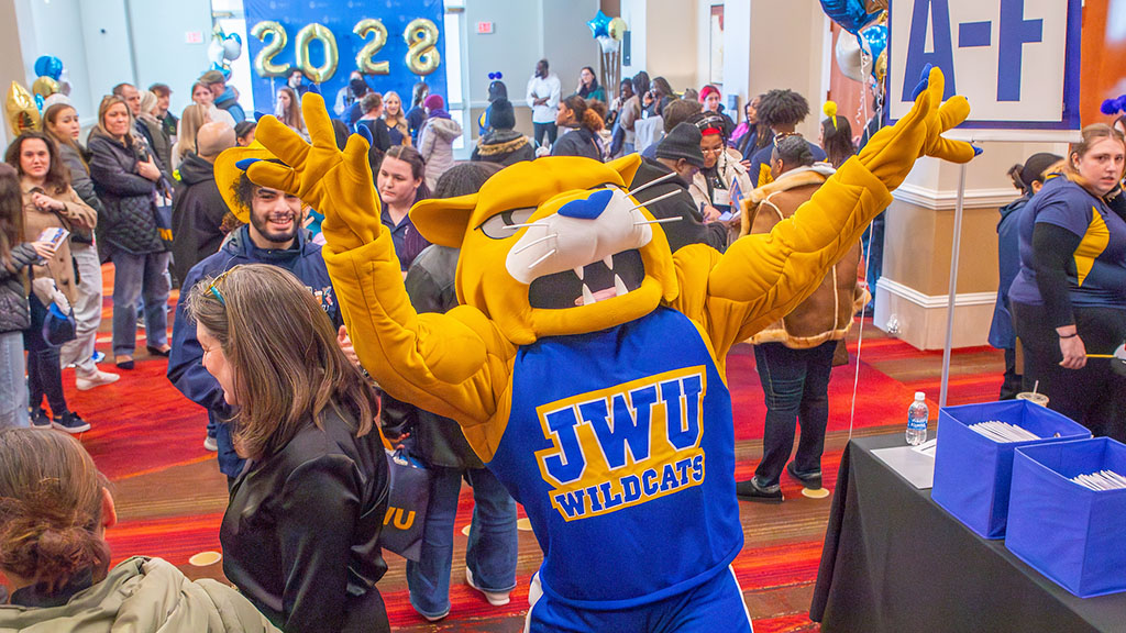 Wildcat Willie walking through a crowd of people at ASD