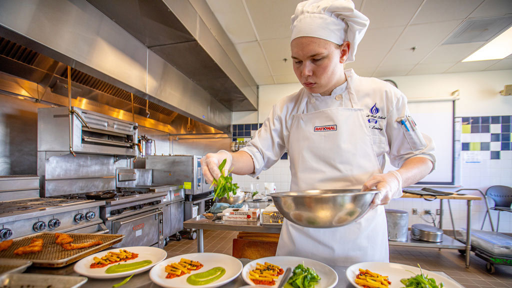 Benjamin "Cooper" Leming concentrates on plating his entree for the Future Food Competition