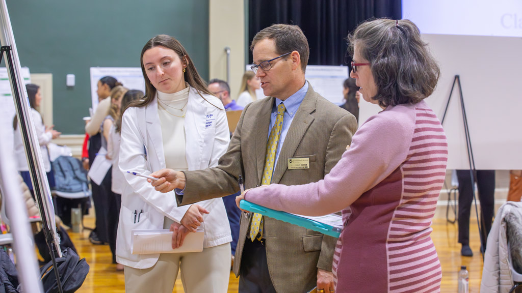 PA student Aris Degaitas, left, is captured in a candid photo at 2024 PA Scholarship Day