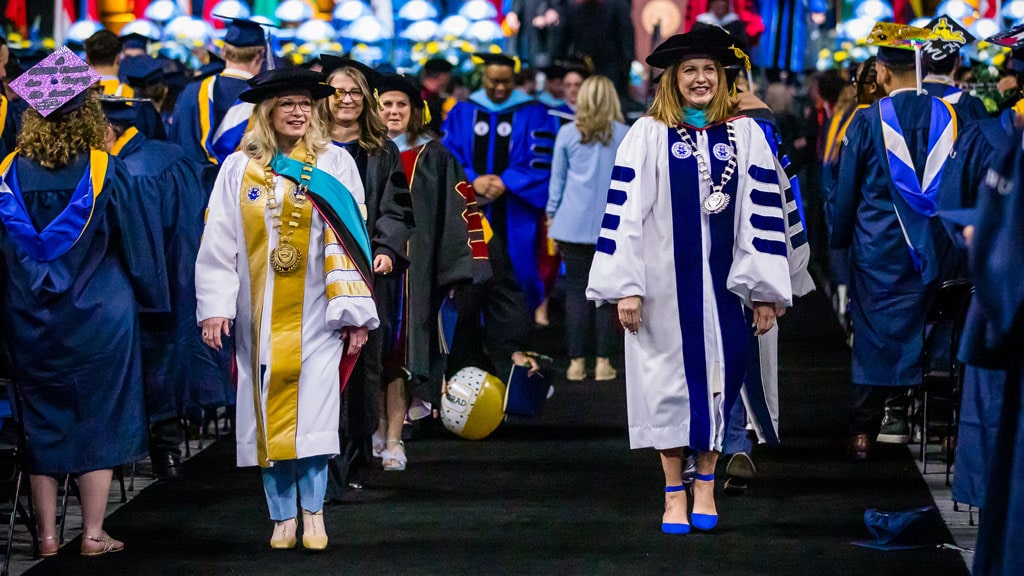 Chancellor Mim Runey and Provience Campus President Marie Bernardo-Sousa lead the academic procession at Commencement.