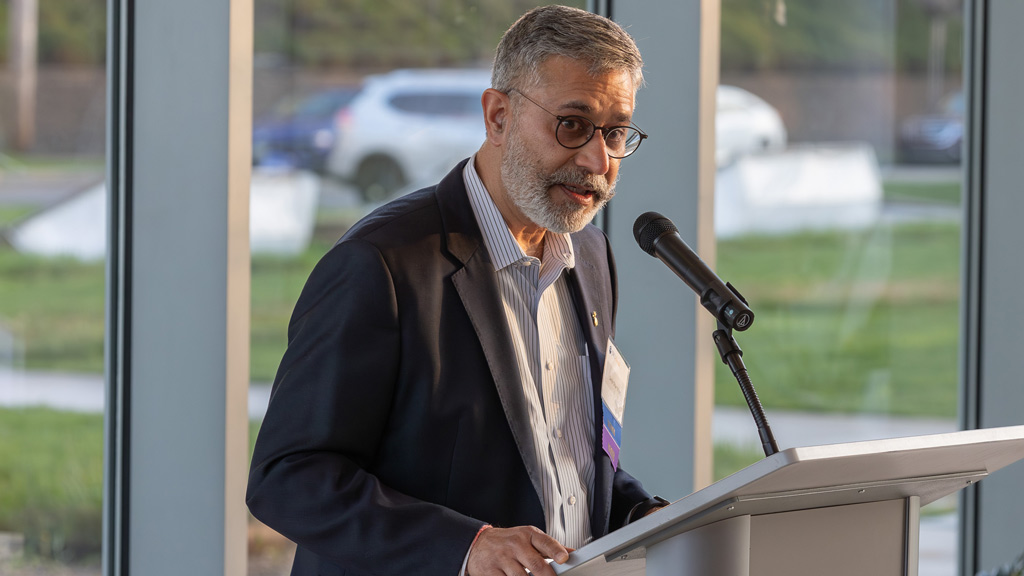 photo of Sanjiv Dhar ’90 M.S. speaking at a podium