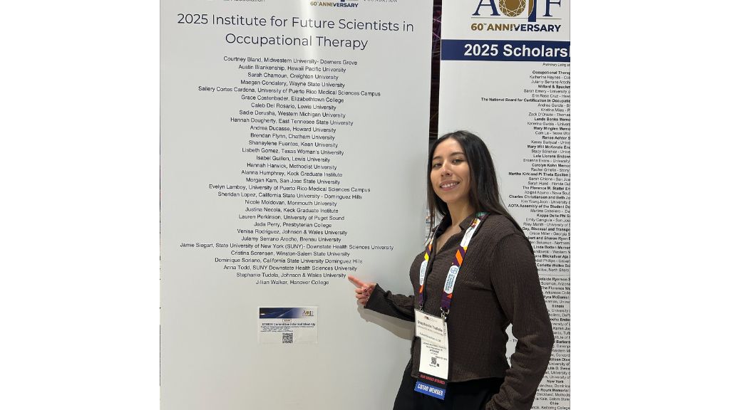 Stephanie Tudela ’26 poses in front of a list containing her name