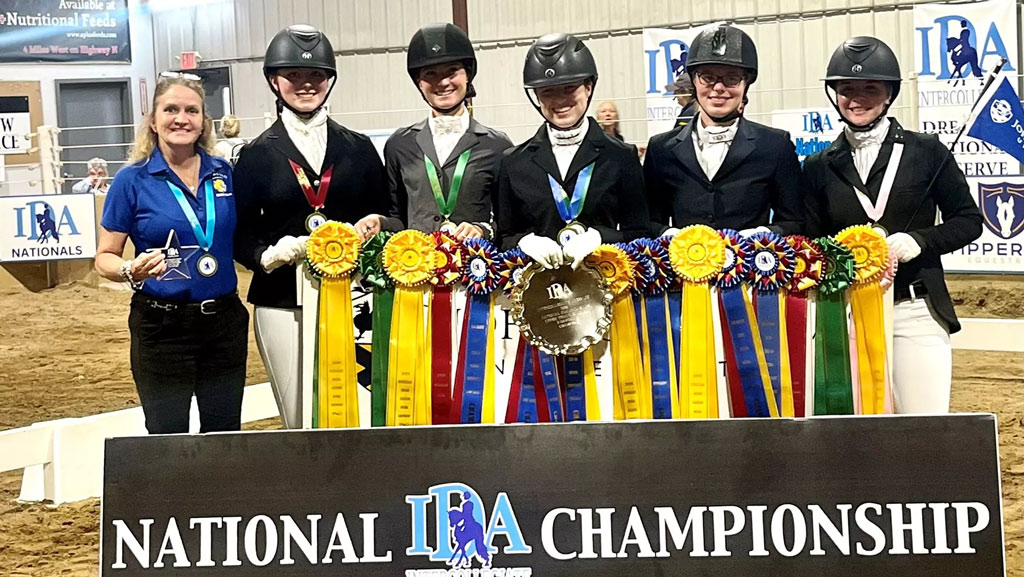 photo of JWU's IDA team holding their 2025 championship ribbons