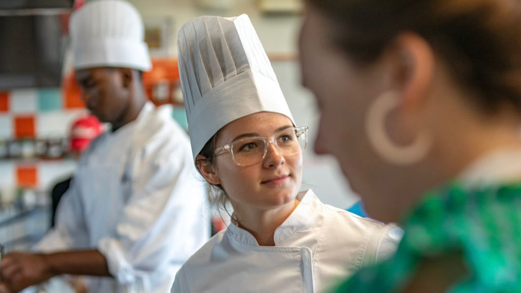 Class of 2025 Speaker Amelia Warfel in a CFIT kitchen.