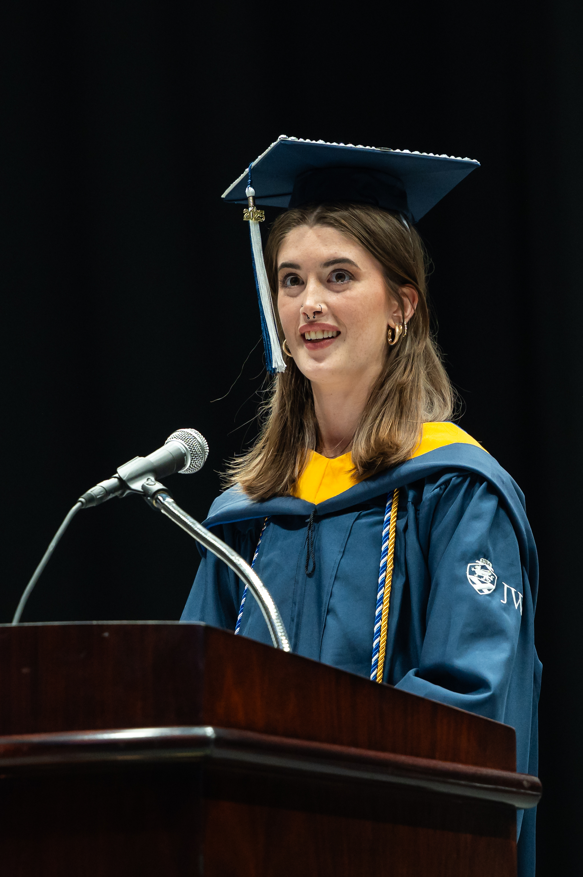 Savannah Riley speaking at the 2025 JWU Charlotte Commencement ceremony.