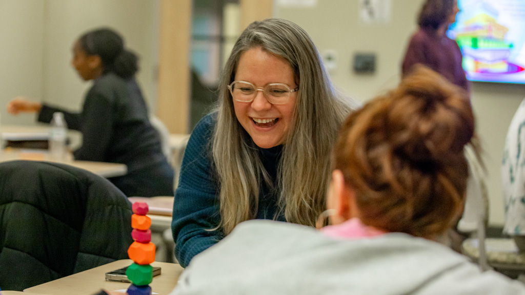 Doctoral student using tools with other students