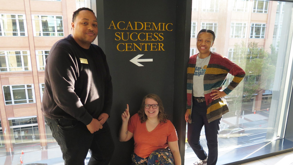 photo of three staff members in front of JWU Charlotte's Academic Success Center