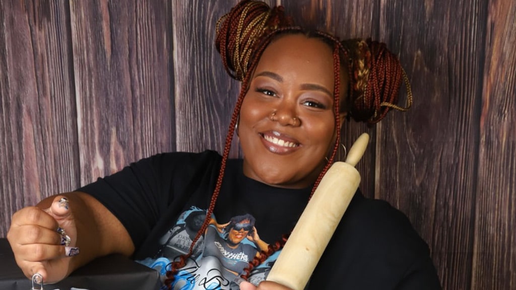 photo of Zhya Williams '25 posing with a rolling pin