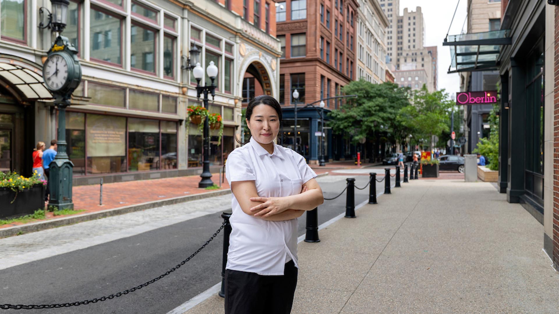 Sky Haneul Kim poses in front of Gift Horse restaurant on Westminster Street in Providence.