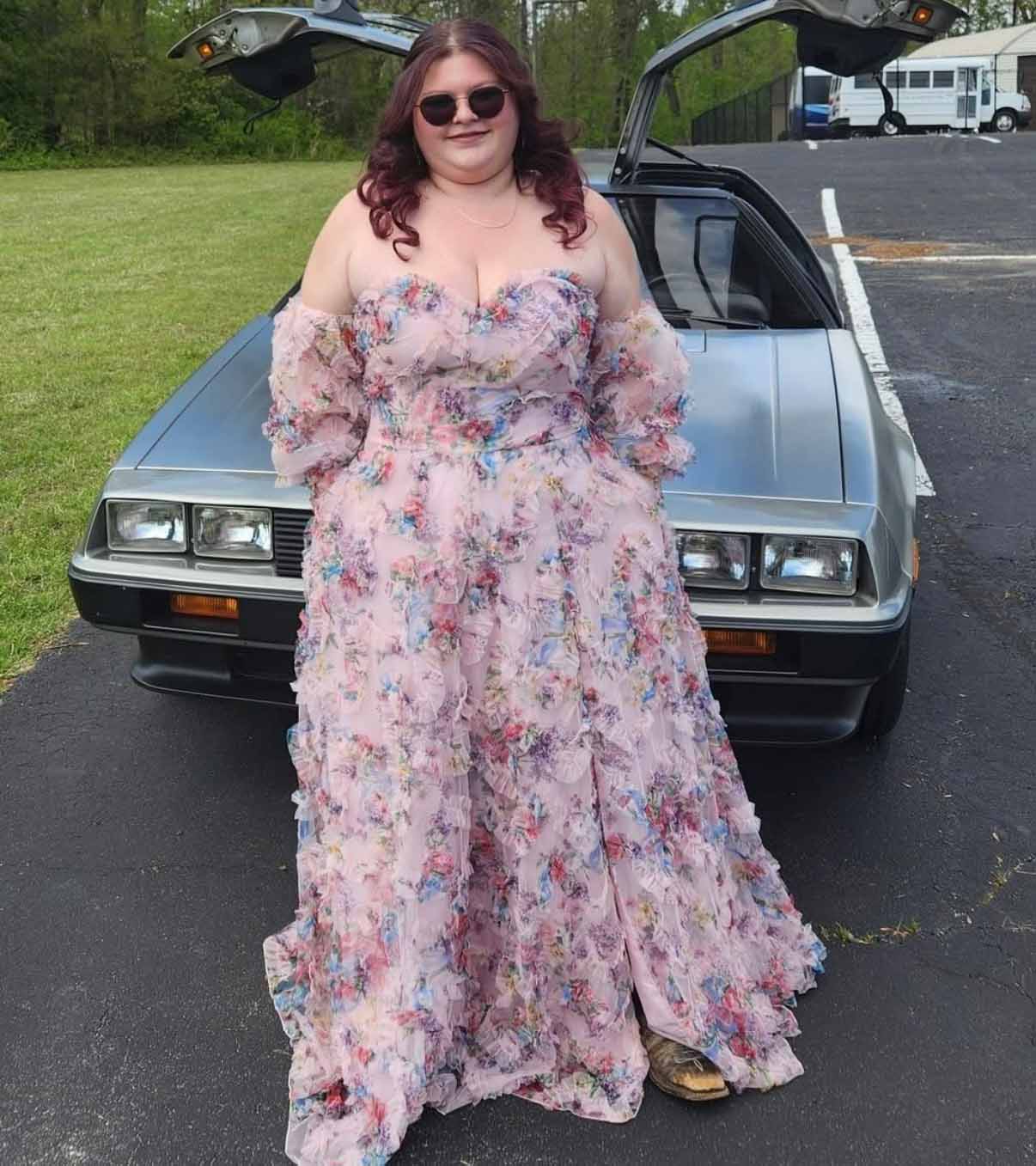Ashley Hart in a pink floral floor length prom dress.