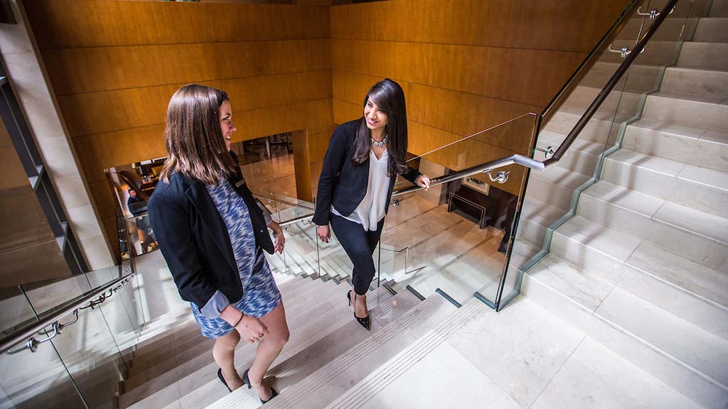 Two hotel management professionals in a hotel setting.