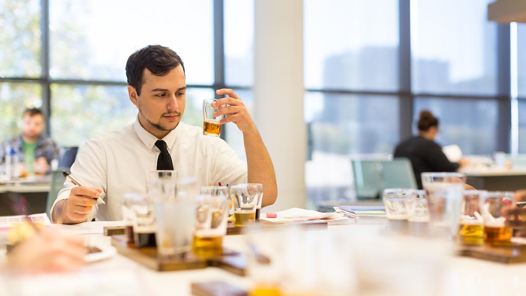 Hospitality student analyzes beverages in the beverage lab.