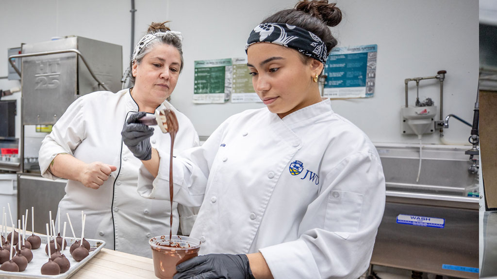 Jennifer Nelson'16, executive pastry chef (L) and Salma Garcia '28 making chocolate concoctions.