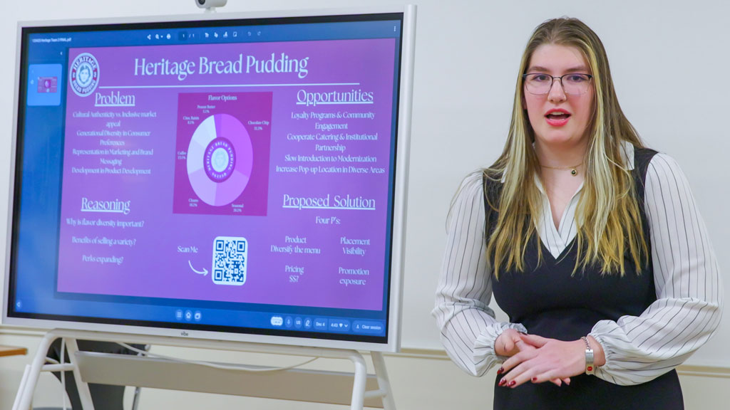 Entrepreneurship student presenting business plan to Camposes, faculty and students