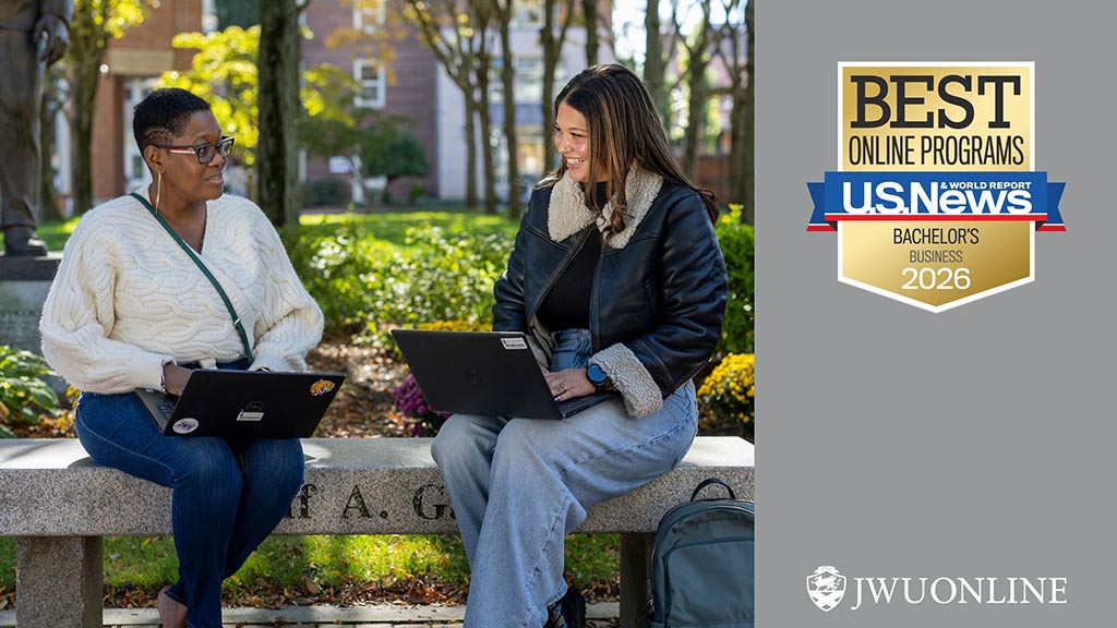 Two students sit on a bench in Gaebe Commons with their laptops; U.S. News & World Report "Best Online Programs - Bachelor's Business 2026" badge
