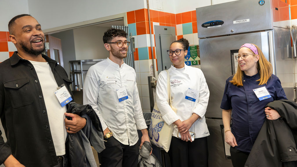 JWU alumni Antonio Wormley '12, Ben Wald '19, Kayla Gaston-Singletary '22 and Rochelle Cooper '12 tour the kitchens during their visit.