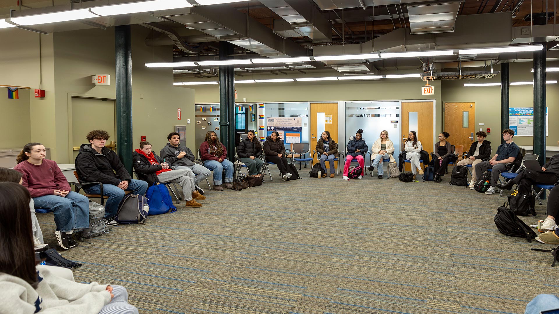 photo of a group of students sitting in a circle having a casual discussion