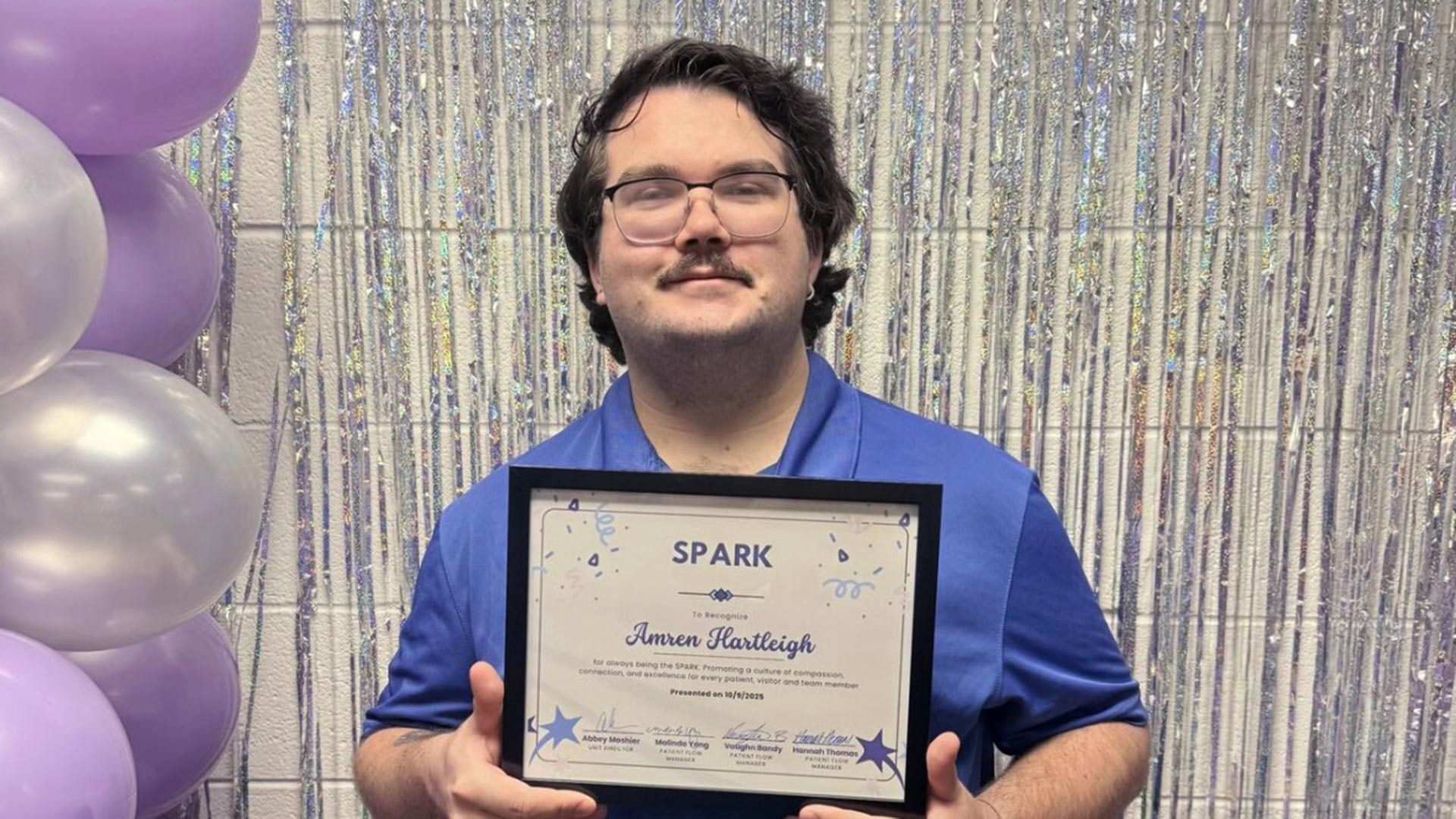 Amren Hartleigh '26 poses holding his SPARK award