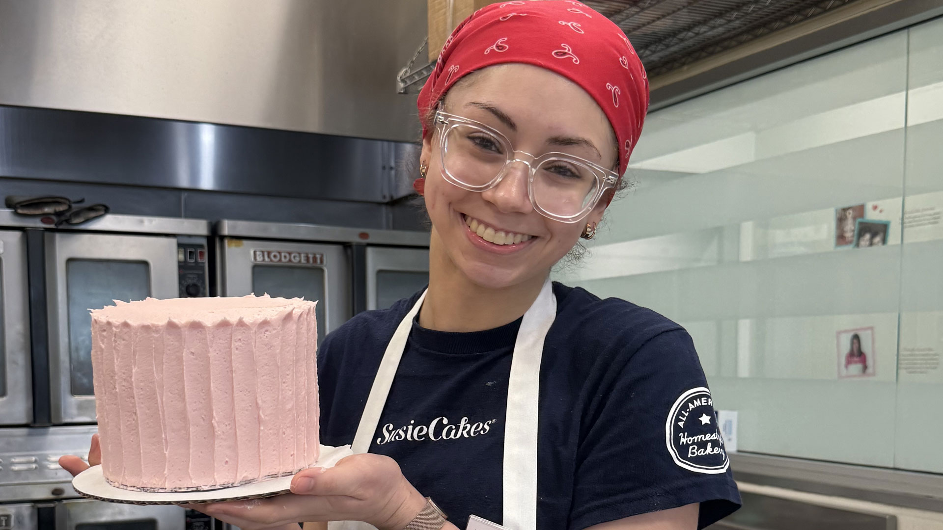 JWU student Zoe Bayat with a frosted cake for Valentine's Day 
