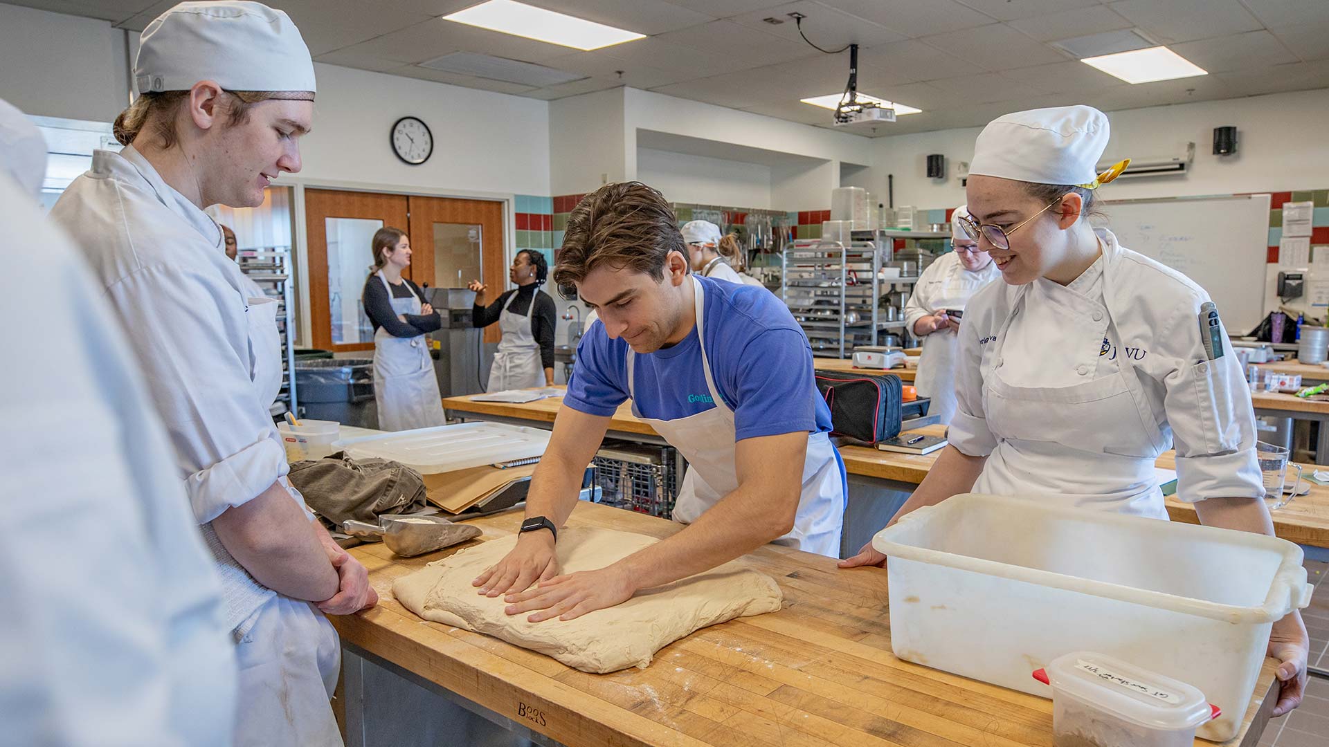 photo of Tufts and JWU students together in a culinary lab