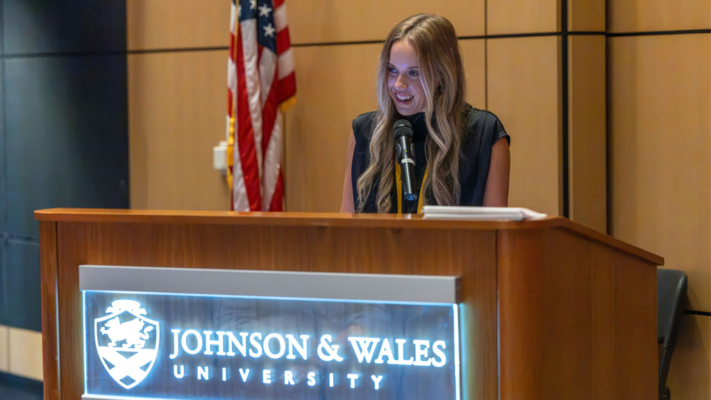 A student receiving her ribbon from the nursing pining ceremony.