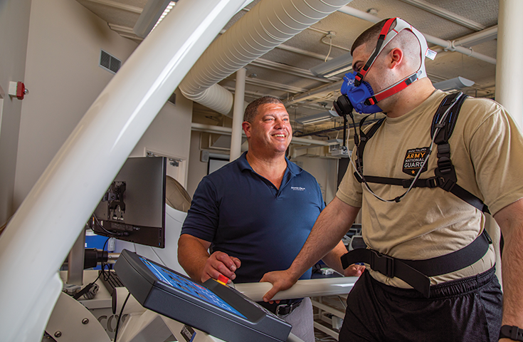 Associate Dean of the College of Health & Wellness Paul Ullucci PT, Ph.D., DPT, ATC, SCS, CSCS works with students to test equipment in Johnson & Wales new Exercise Sports Science lab