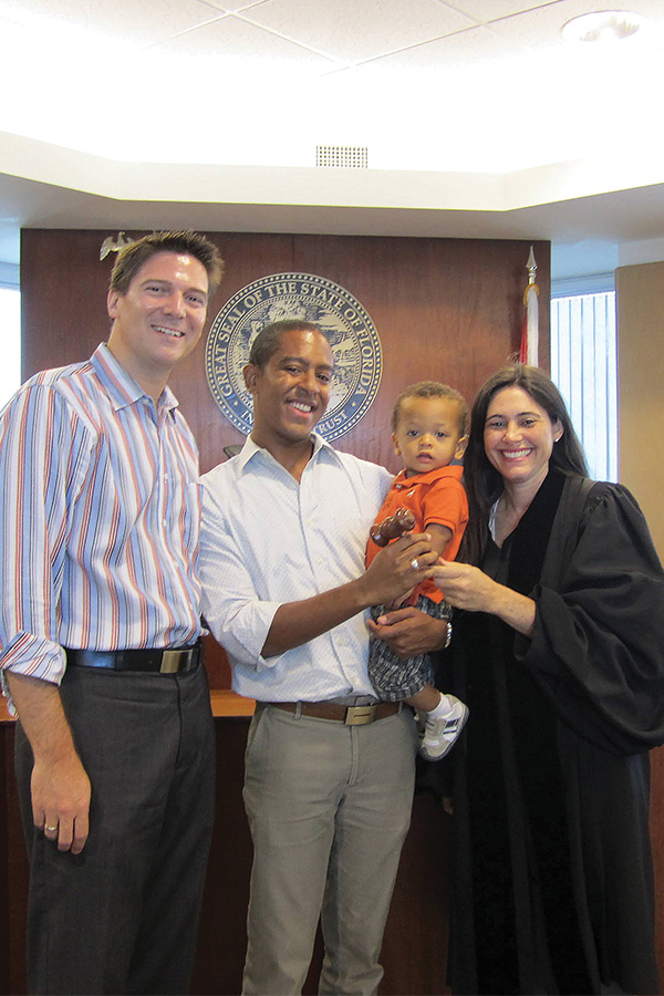 Jeff and Todd Delmay with their baby boy and judge