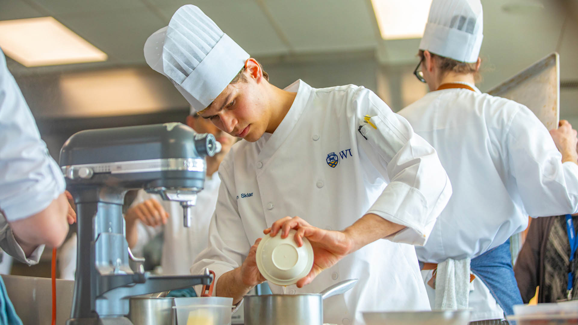 Daron Sklar working in a kitchen in a chef's uniform