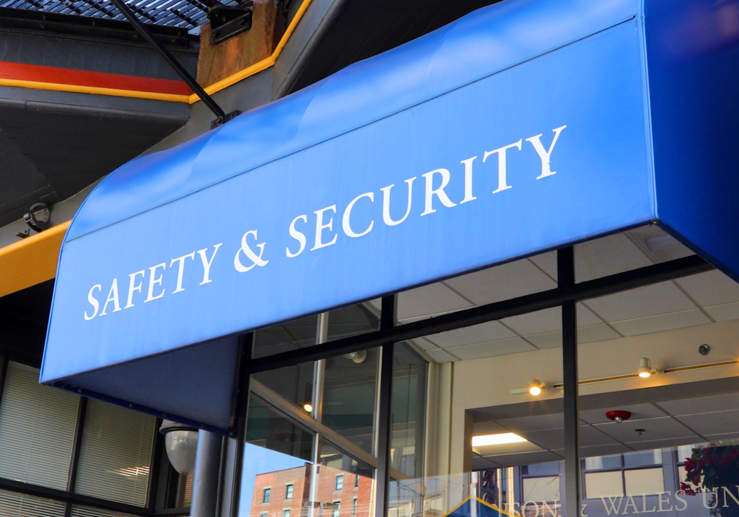 Johnson & Wales University Providence Campus Safety and Security - awning with safety and security logo attached to building exterior