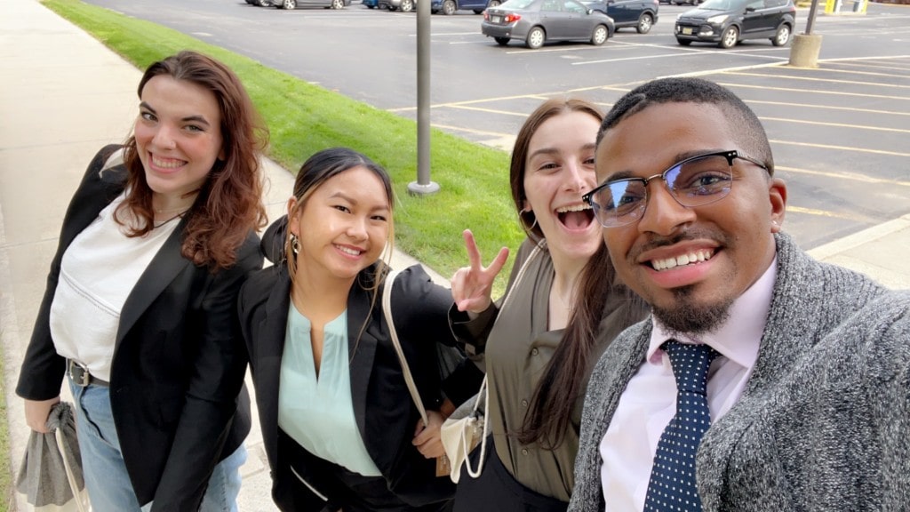 Hospitality students pose happily outside of hotel in Boston for Shadow Day