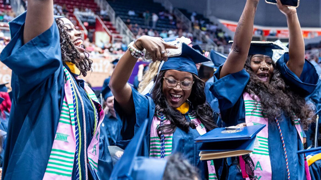 Jubilant graduates in full regalia at a Charlotte Commencement.