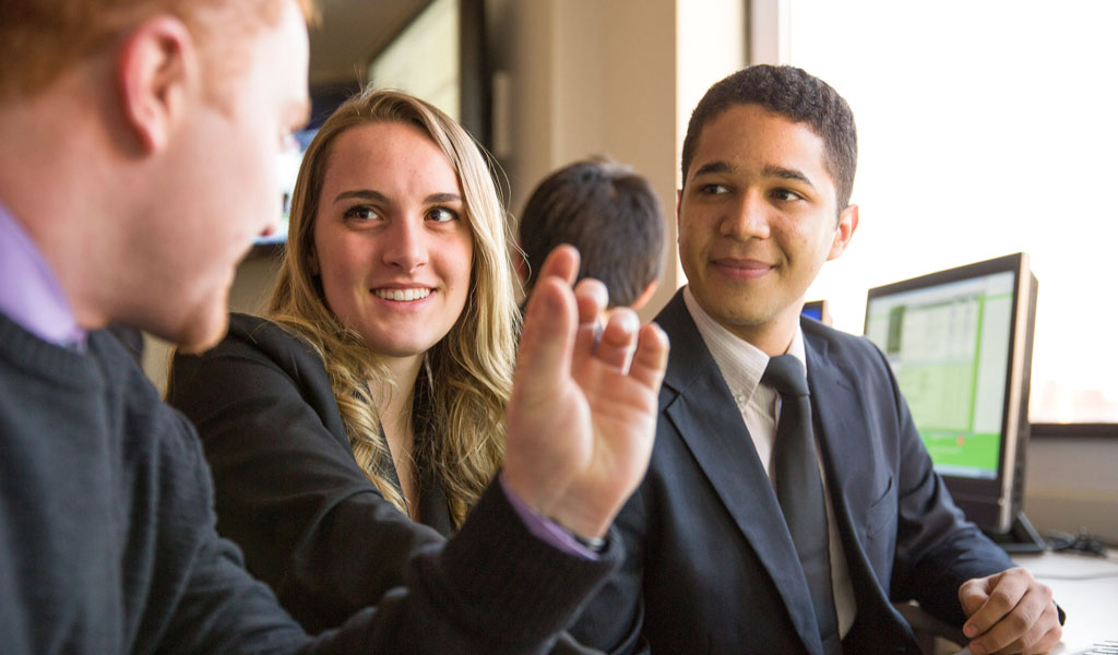 students having a conversation in business class