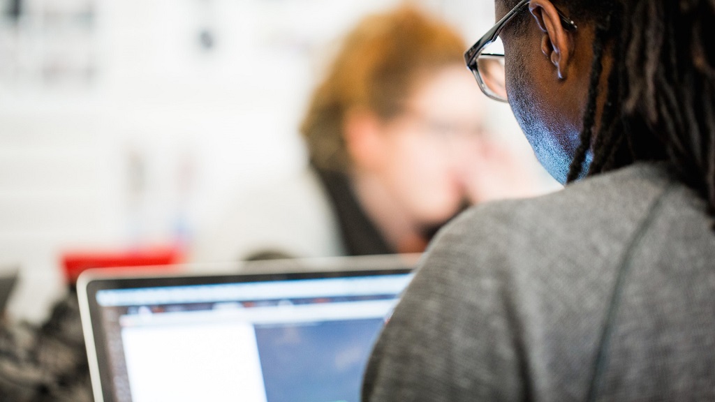 student looking at data analytics on laptop