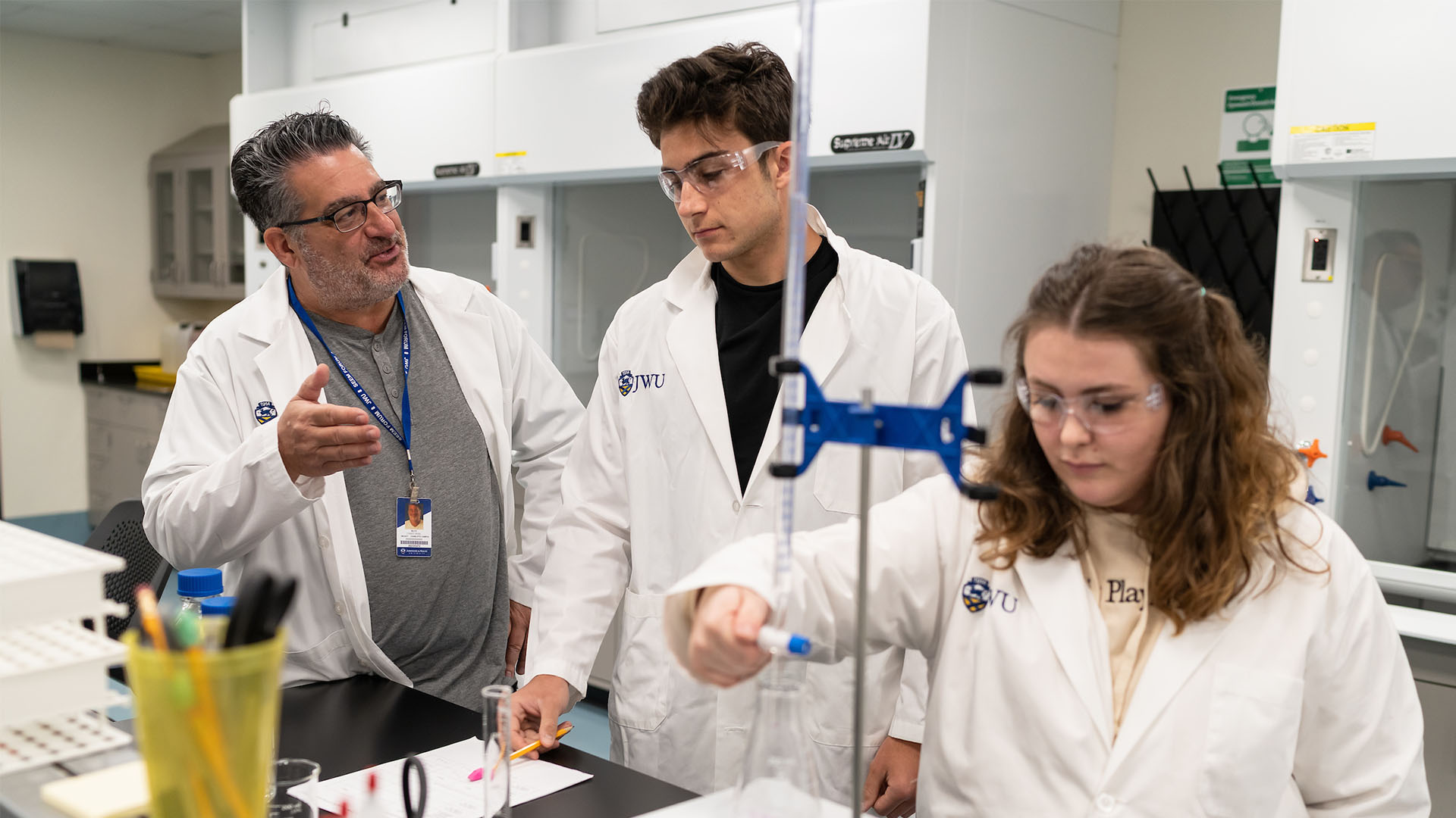student and teachers working in food lab