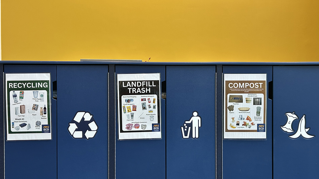 Recycling bins on campus include separate containers for recycling, landfill trash and organic compost.