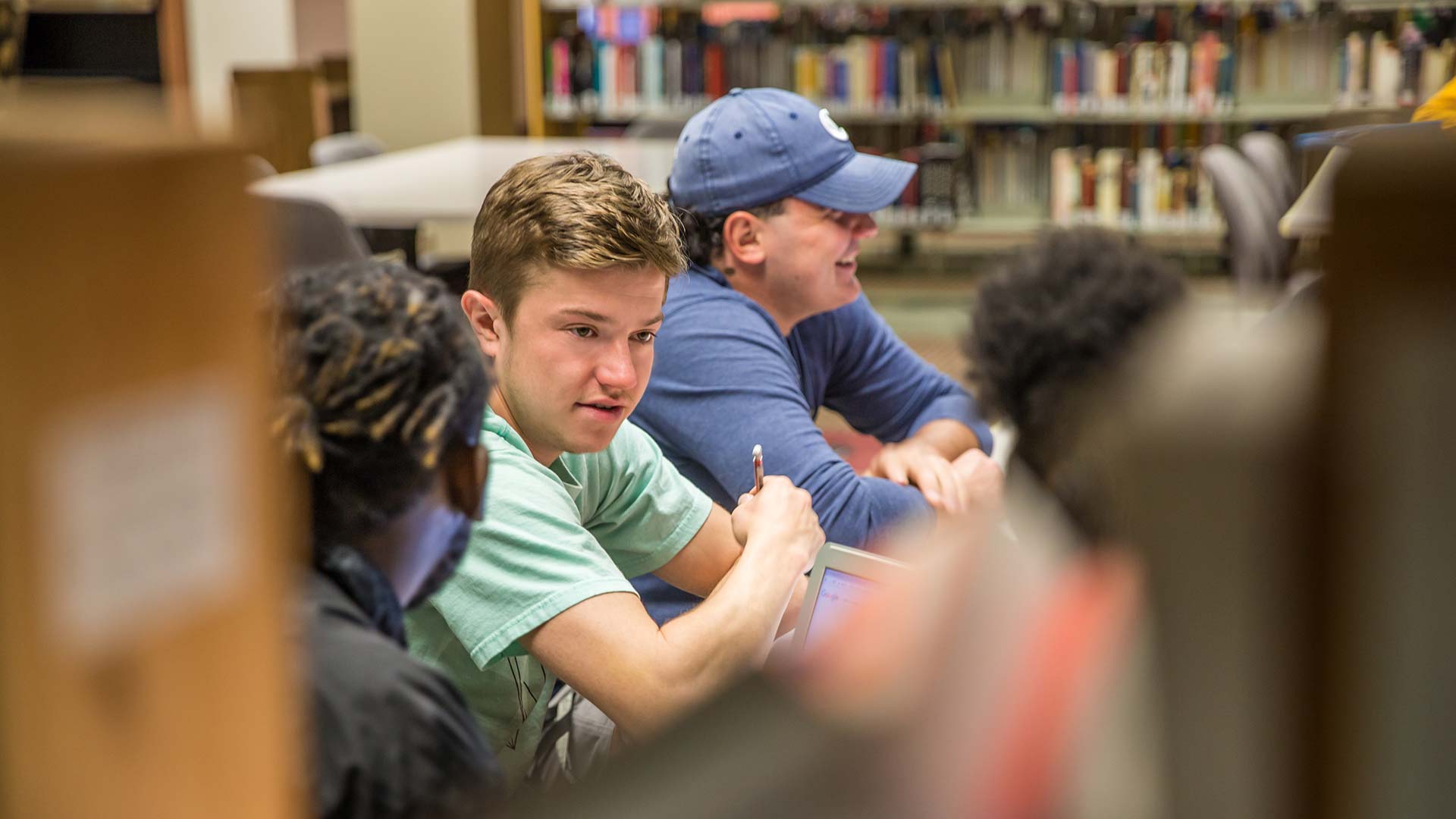 Two male liberal arts students studying in libarary 