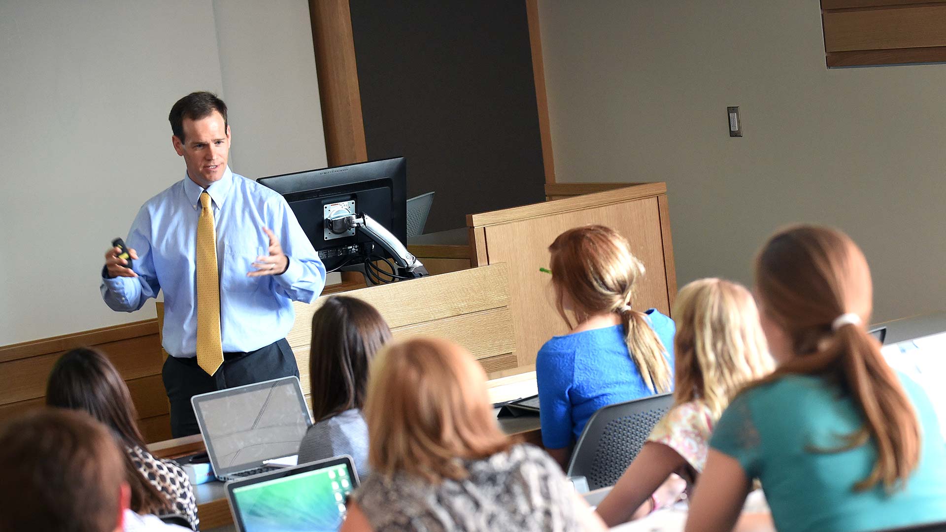 Public health professor in classroom teaching to students