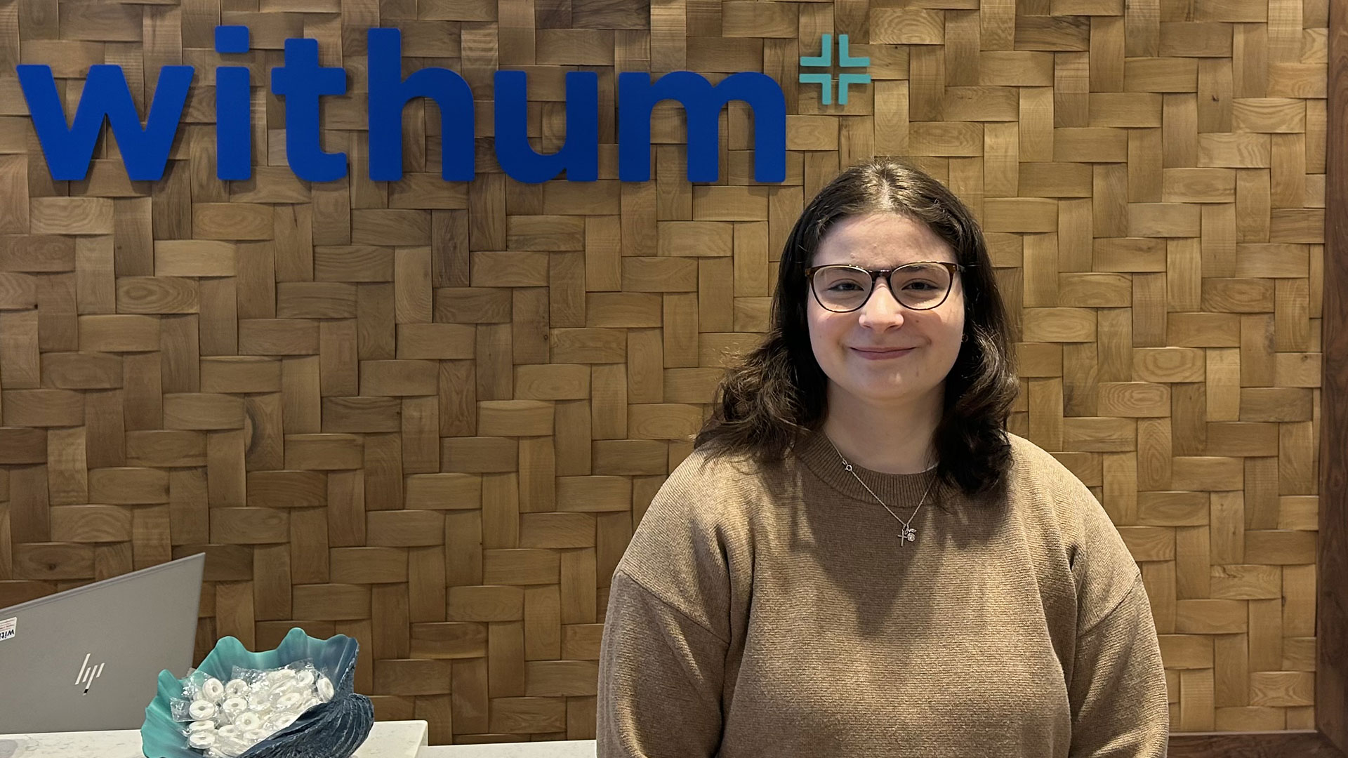 Abigail Rendock ’27 poses in Withum’s office in downcity Providence.