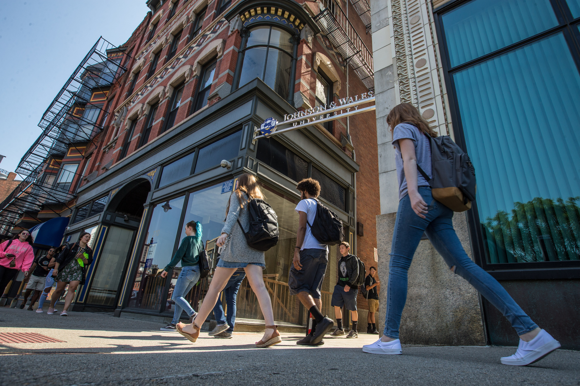 A group of persons walking down the street.