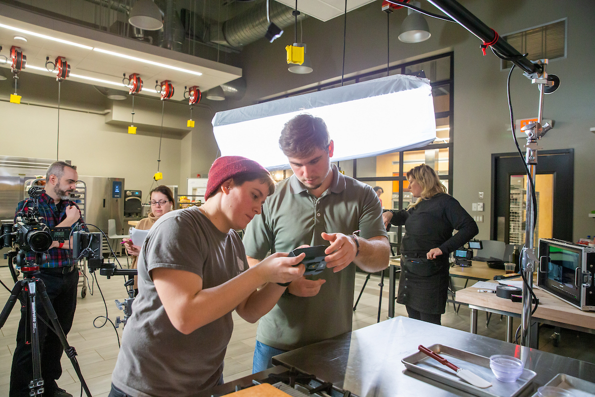 Henry Schott, media and communications / criminal justice majors, filming for Animus Studios during his internship